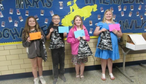 Fifth grade students from St. Marys show their winning notepad designs. 